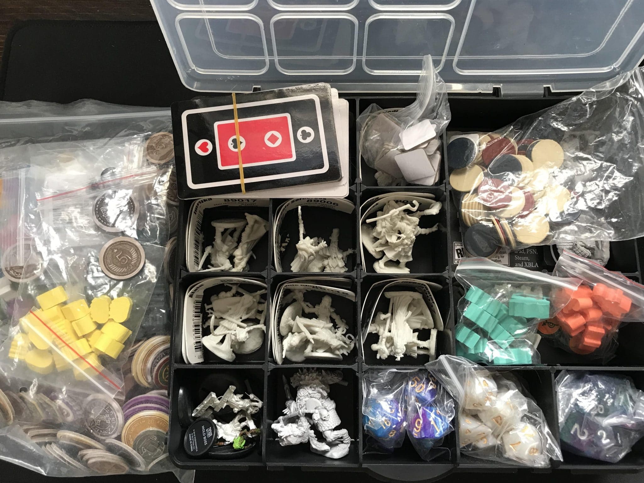 Box featuring assorted tools for game design like dice, tokens, minis, and cards.