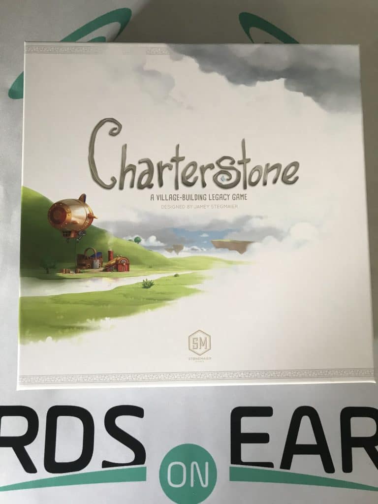Charterstone box featuring an airship with a small village forming under a blue and white sky.