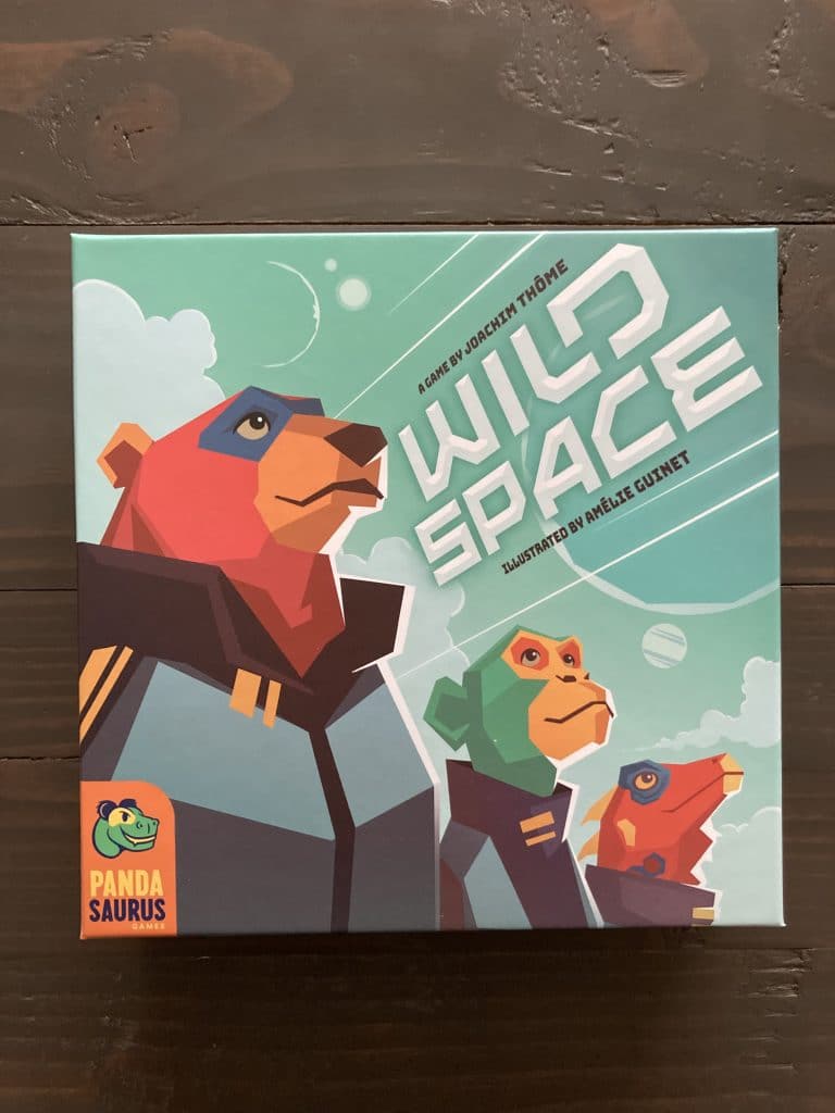 A red bear, green monkey, and red lizard stand stoically in gray space uniforms, looking up to the stars. "Wild Space" is the game title, angled up to the right in a techy font. Pandasaurus Games logo in the bottom left.