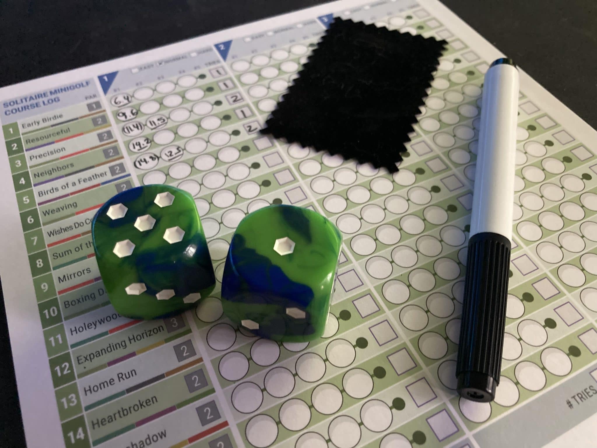 Rolling Realms board game dice and solitaire scoring sheet